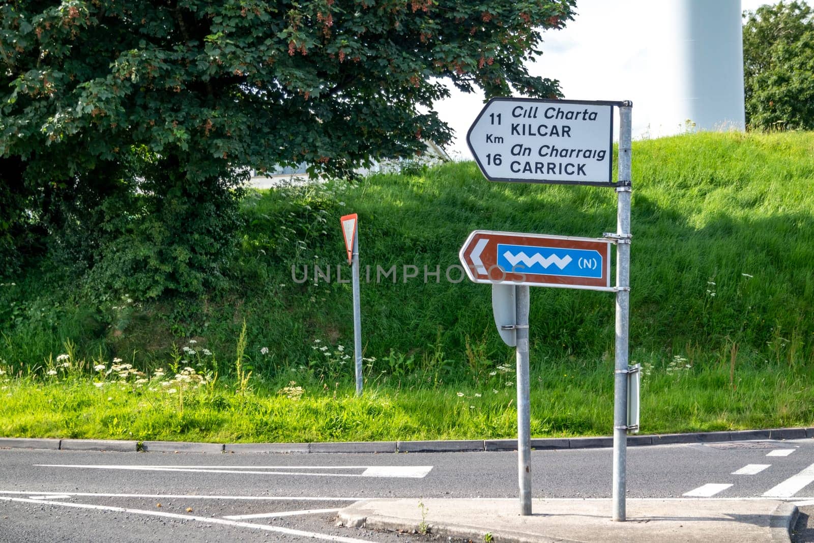 KILLYBEGS, IRELAND - MAY 16 2023: The sign at the roundabout is showing the way to Kilcar and Carrick.