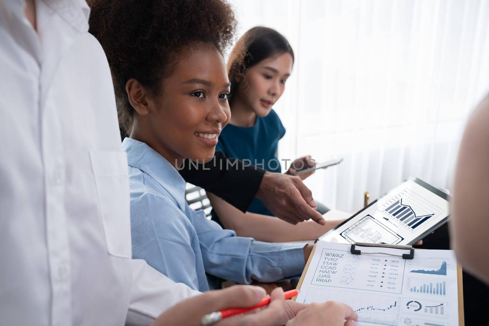 Multiracial analyst team use BI Fintech software to analyze financial data on meeting table. Financial dashboard data display on laptop screen with analyzed chart for marketing indication. Concord