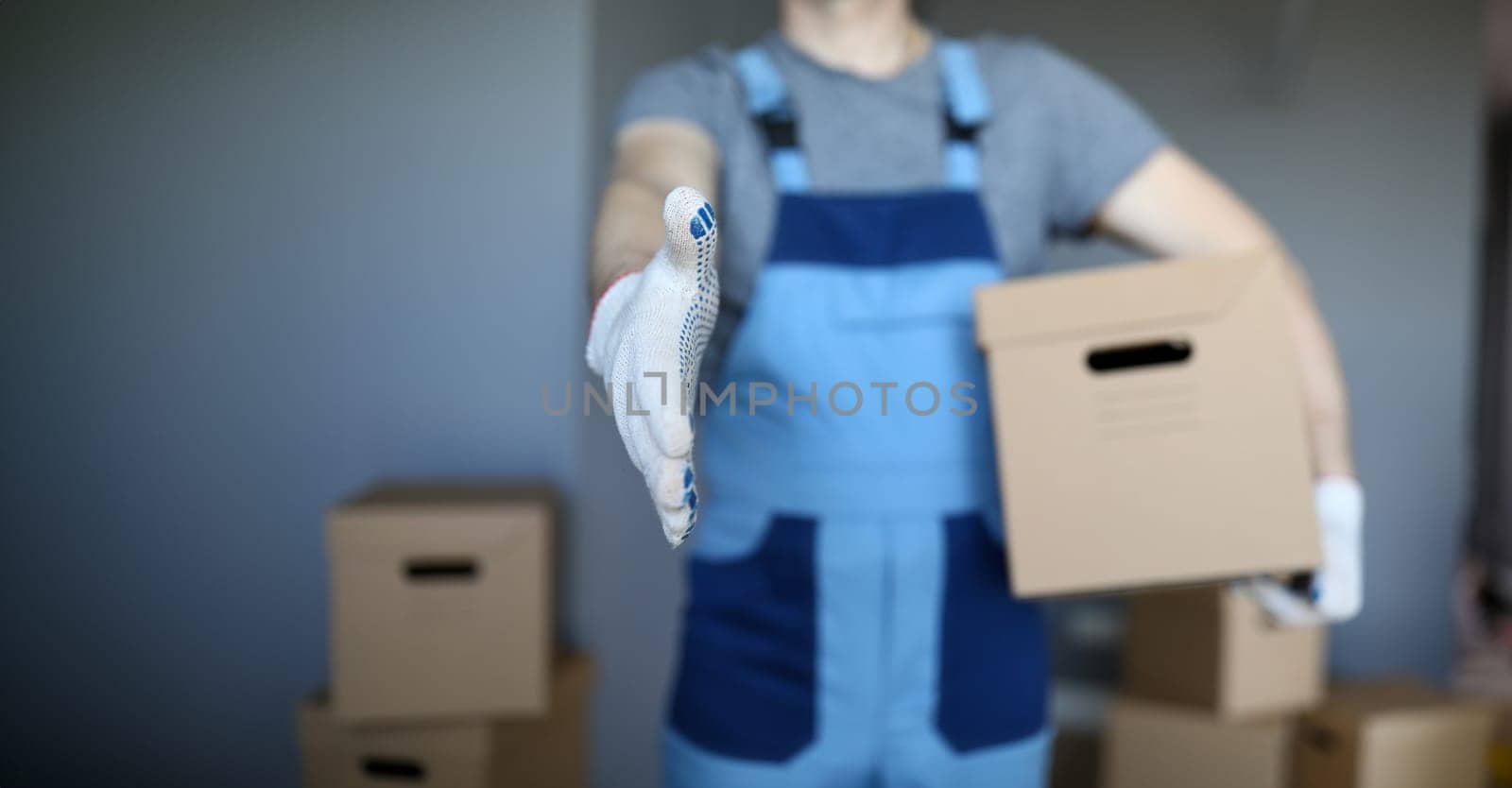 Male hand hold cardboard against new flat closeup background. Fast delivery service concept