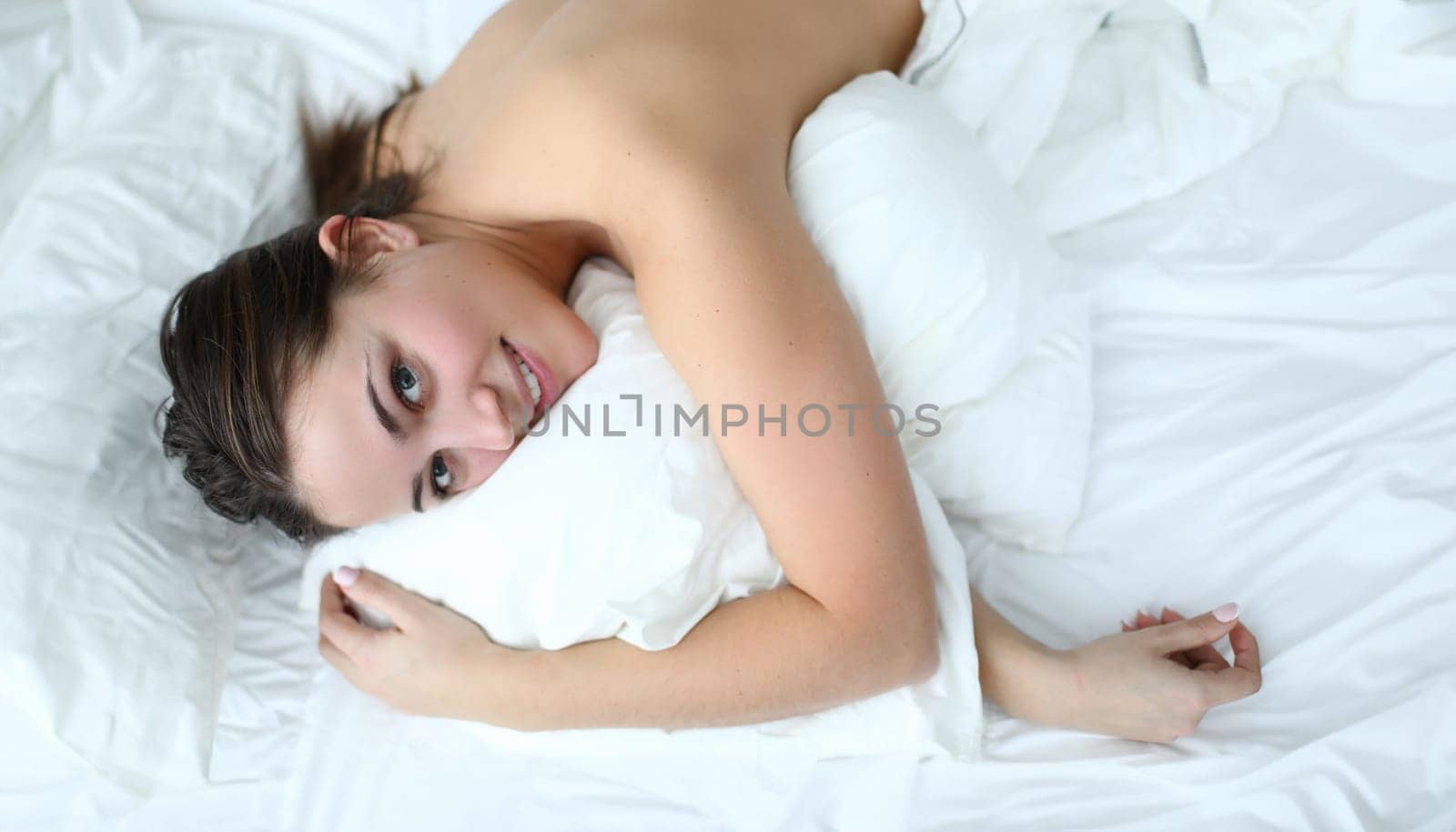 Morning girl relaxed lying white bed and smiling by kuprevich