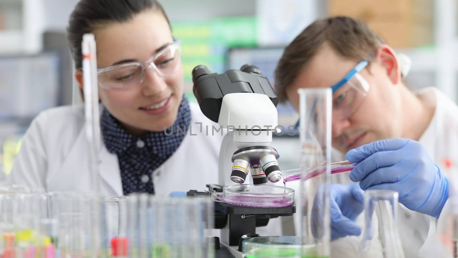 Laboratory assistants conduct chemical examination by kuprevich