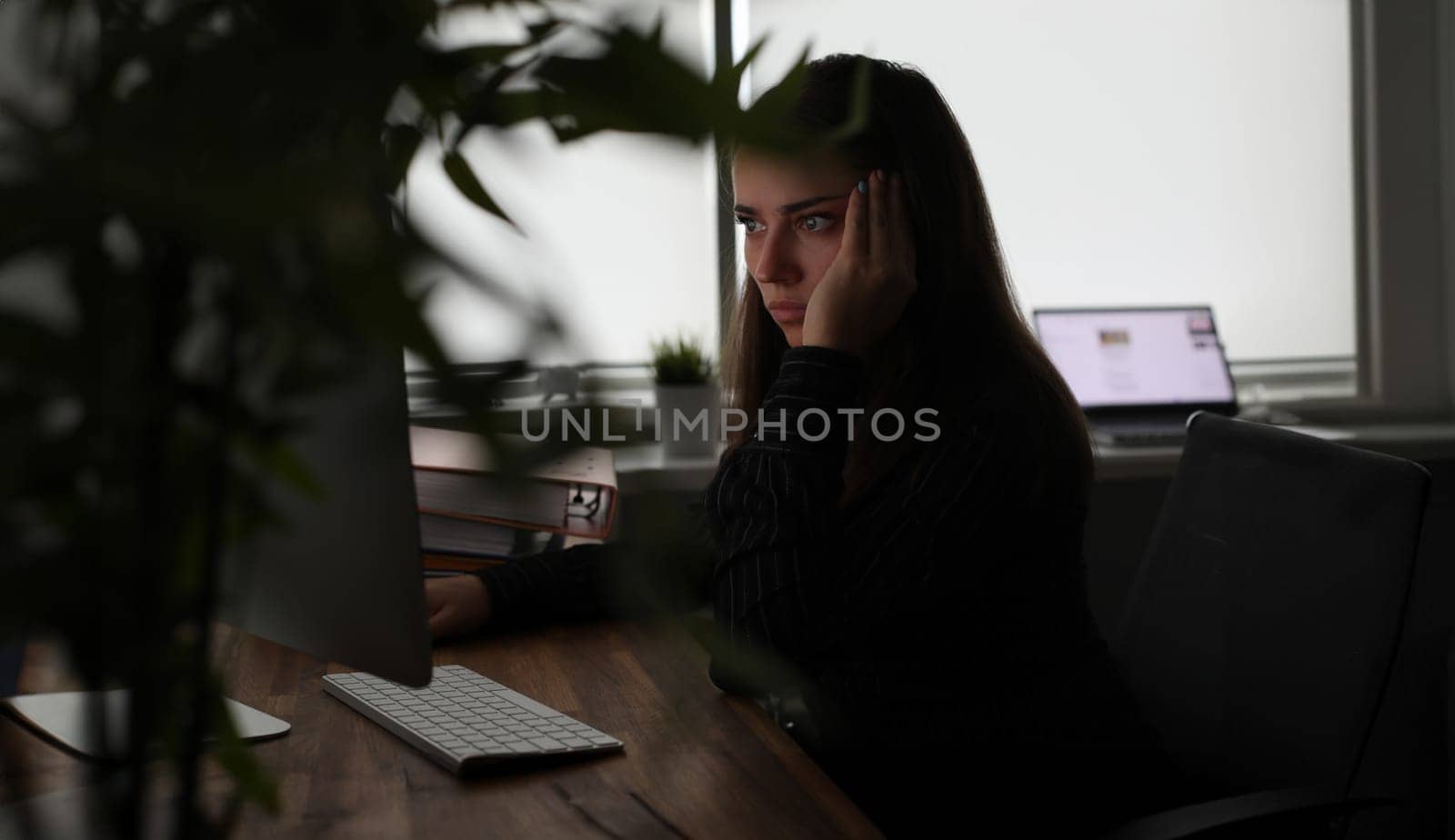 Portrait of concentrated woman in suit working on pc. Tired secretary work long hours. Exhausted businesswoman at office. Deadline and business company concept