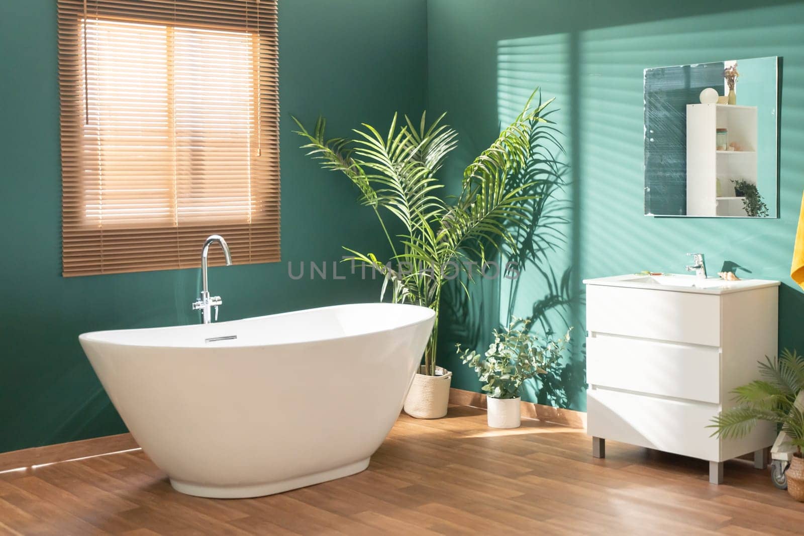 Modern bright bathroom with green walls, wooden floor, plant and window by PaulCarr