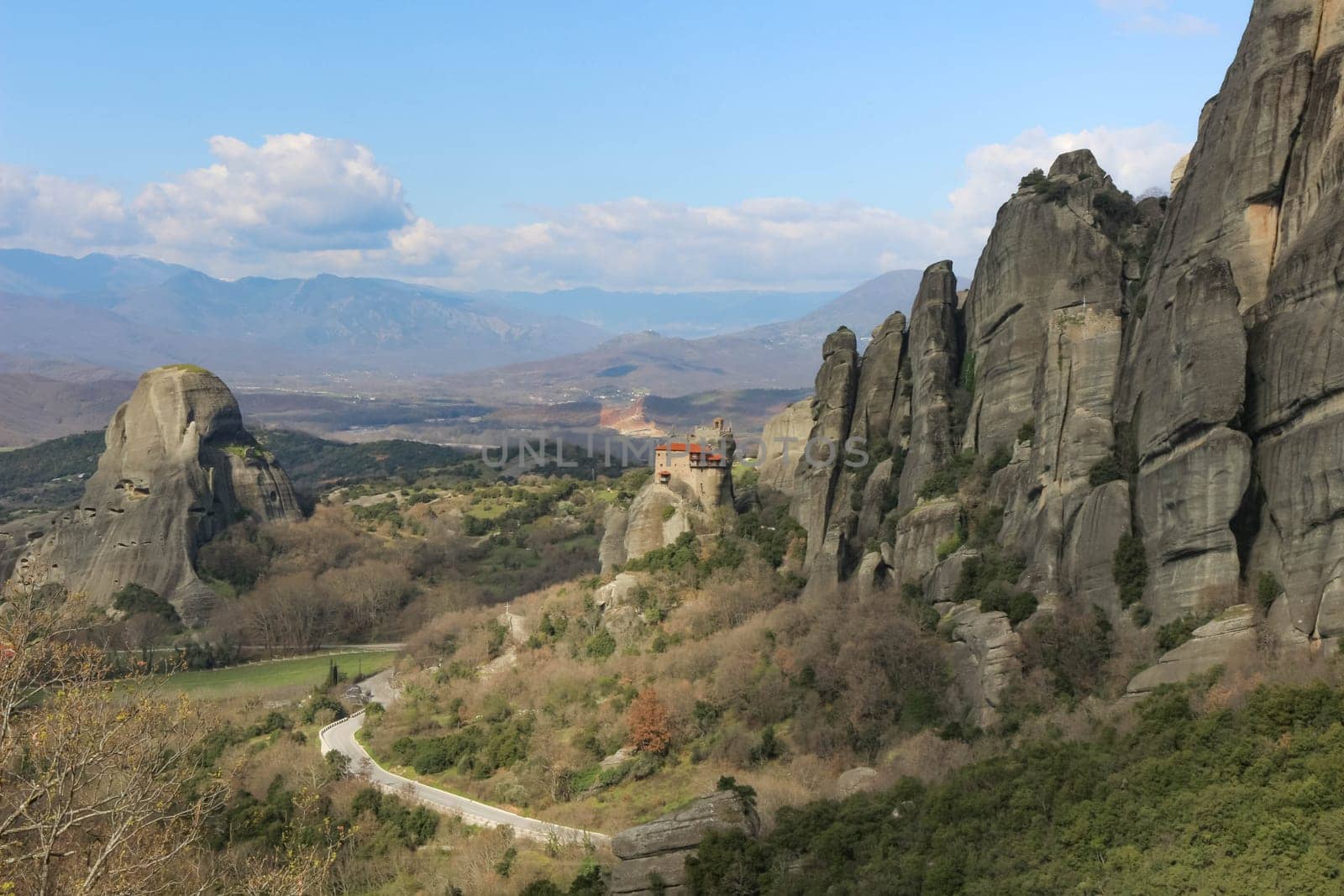 Discover serenity amidst the grandeur of Meteora's towering cliffs, where the smallest of churches offers a tranquil retreat amidst breathtaking natural beauty