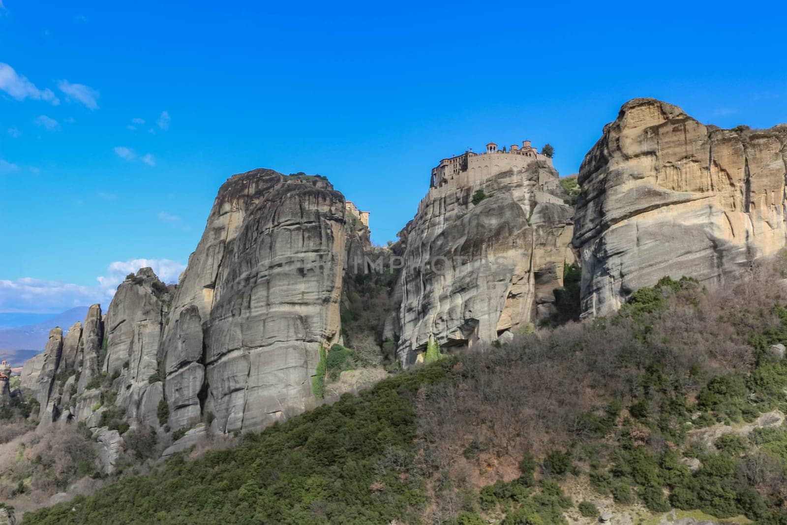 Experience the awe-inspiring beauty of the church nestled atop a cliff in Meteora, Greece, a testament to human ingenuity and spiritual devotion