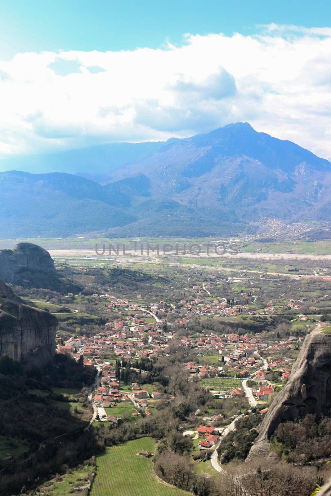 Immerse yourself in the panoramic beauty of Kalambaka, Greece, as seen from the timeless vantage point of the monasteries perched atop the towering cliffs of Meteora