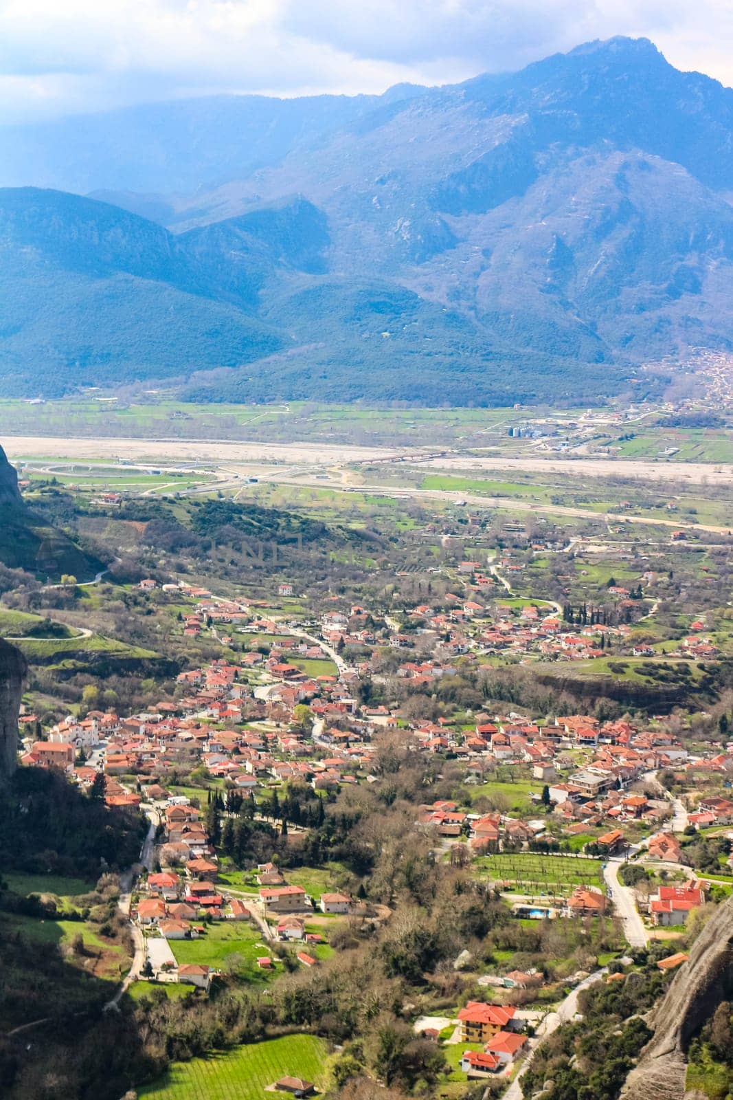 Immerse yourself in the panoramic beauty of Kalambaka, Greece, as seen from the timeless vantage point of the monasteries perched atop the towering cliffs of Meteora