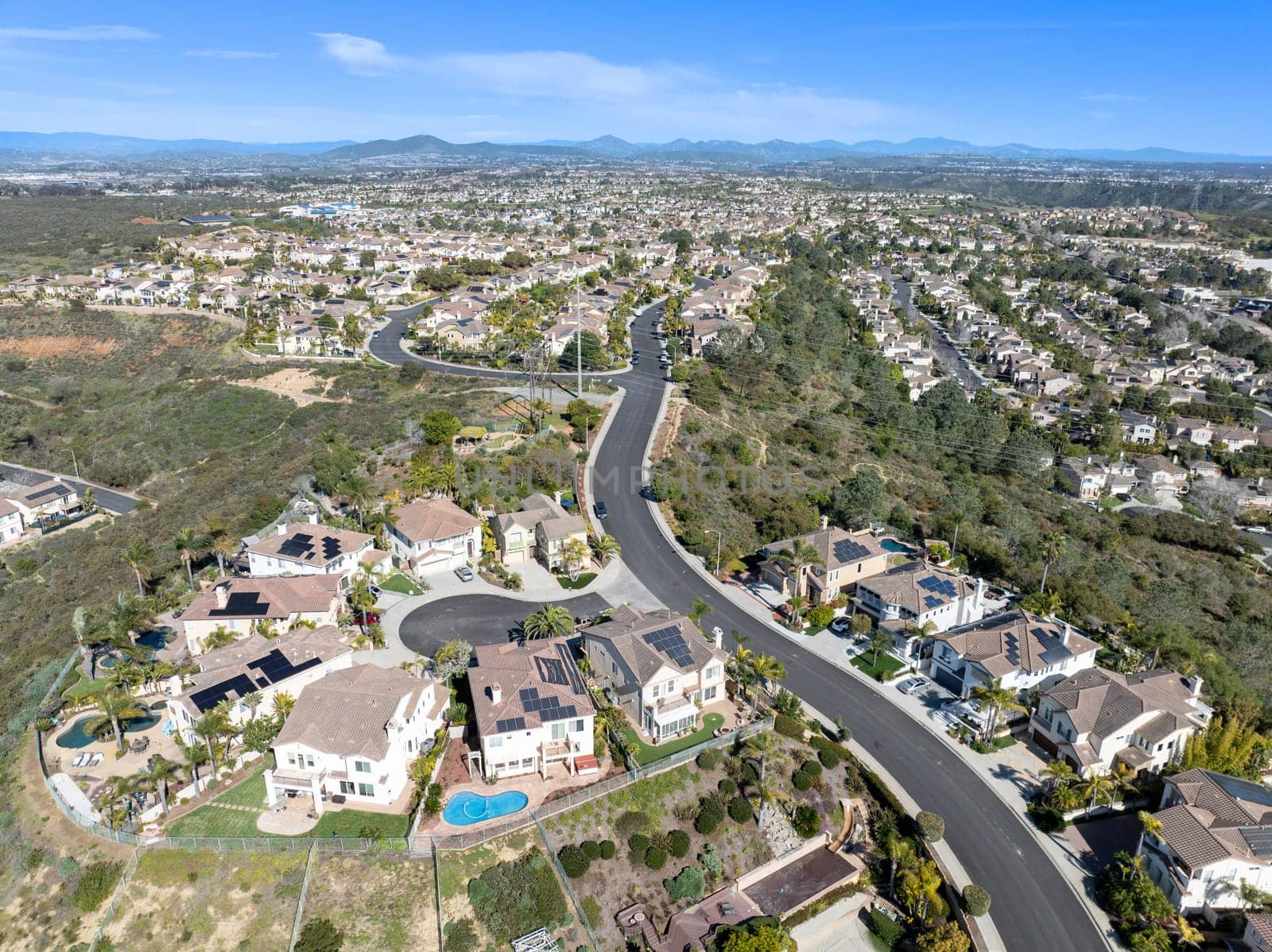 Aerial view of middle class subdivision neighborhood with residential condos and houses in San Diego, California, USA.