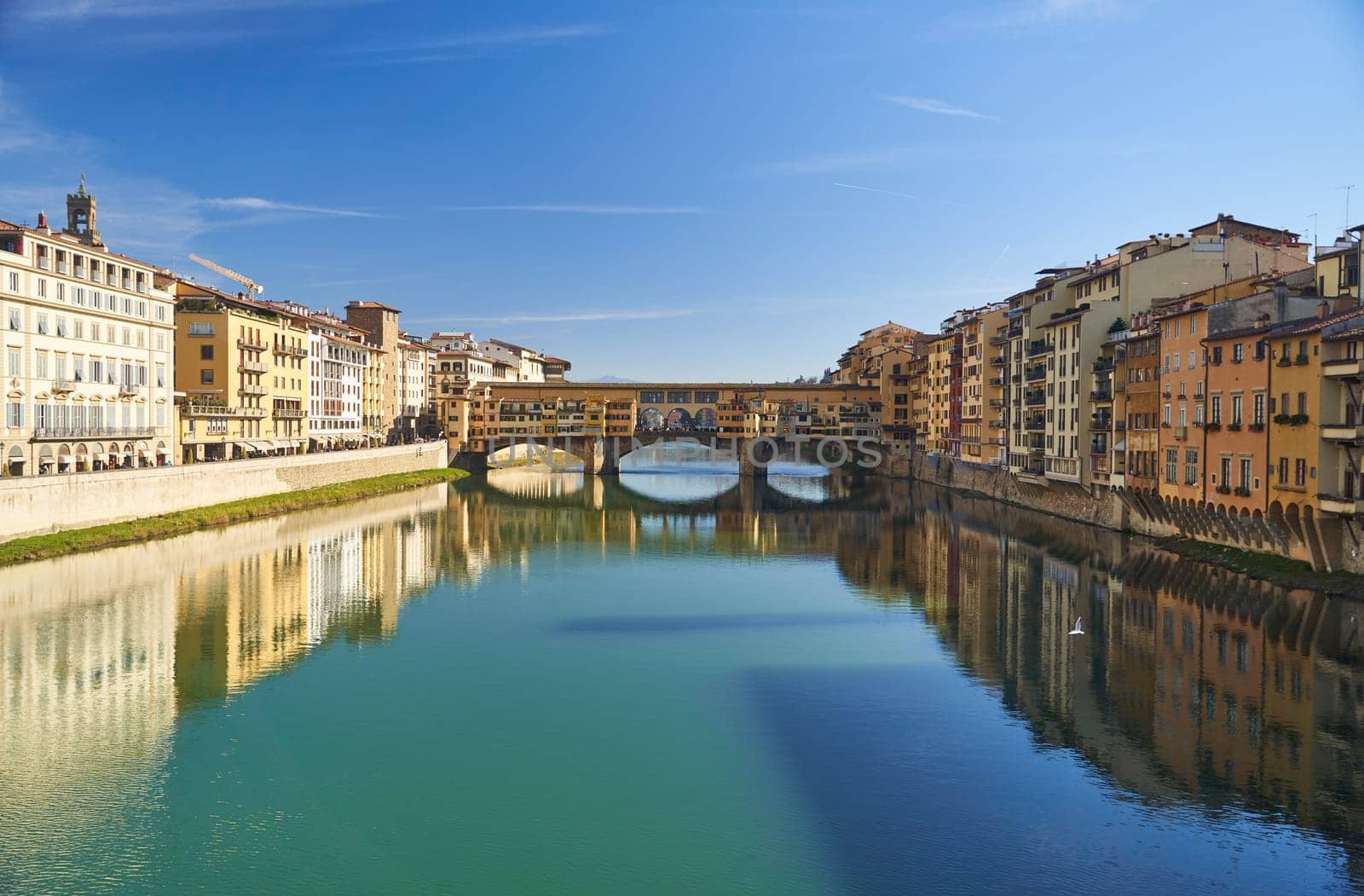 Florence, Italy - 12.02.2023: View of the famous Ponte alle Grazie bridge and the Arno river in Florence. High quality photo