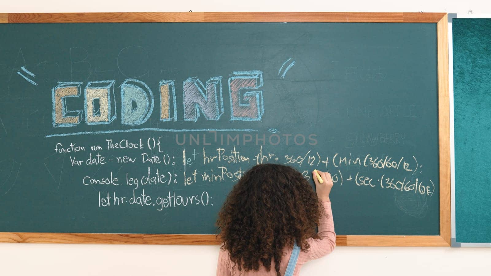 Smart american girl writing engineering prompt and programing system while standing blackboard with generated AI prompt written by diverse smart student at STEM technology lesson. Back view. Pedagogy.