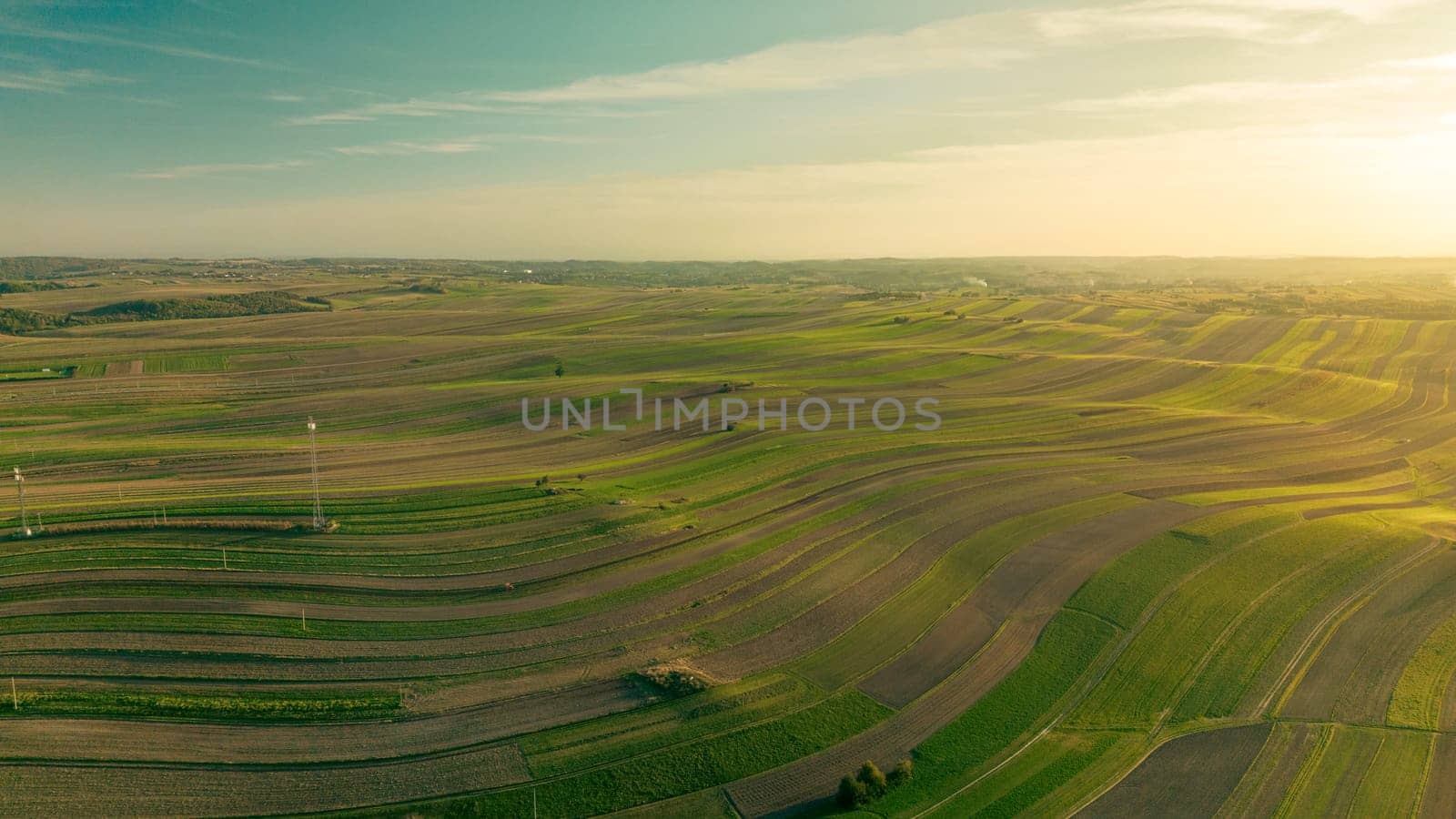 Agricultural fields to horizon at sunset, aerial view of Suloszowa village land in Krakow County, Poland