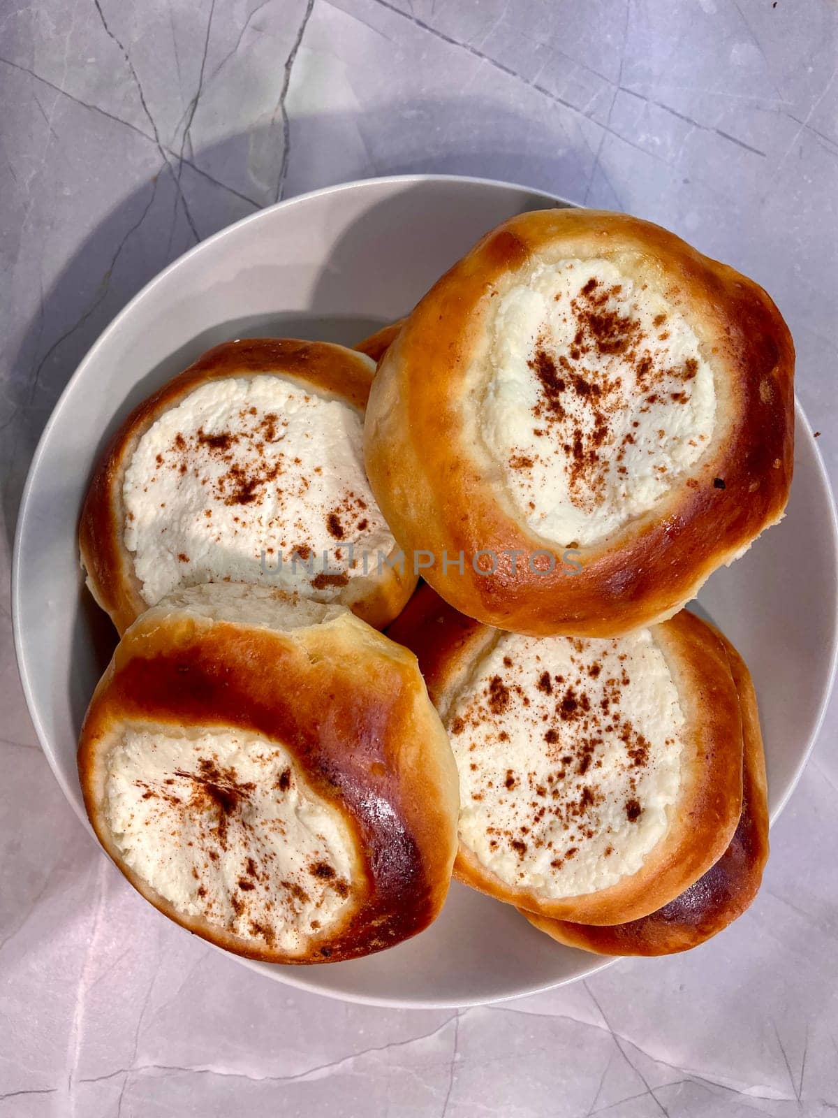 Pies with cheese are baked and ruddy on a gray plate. High quality photo