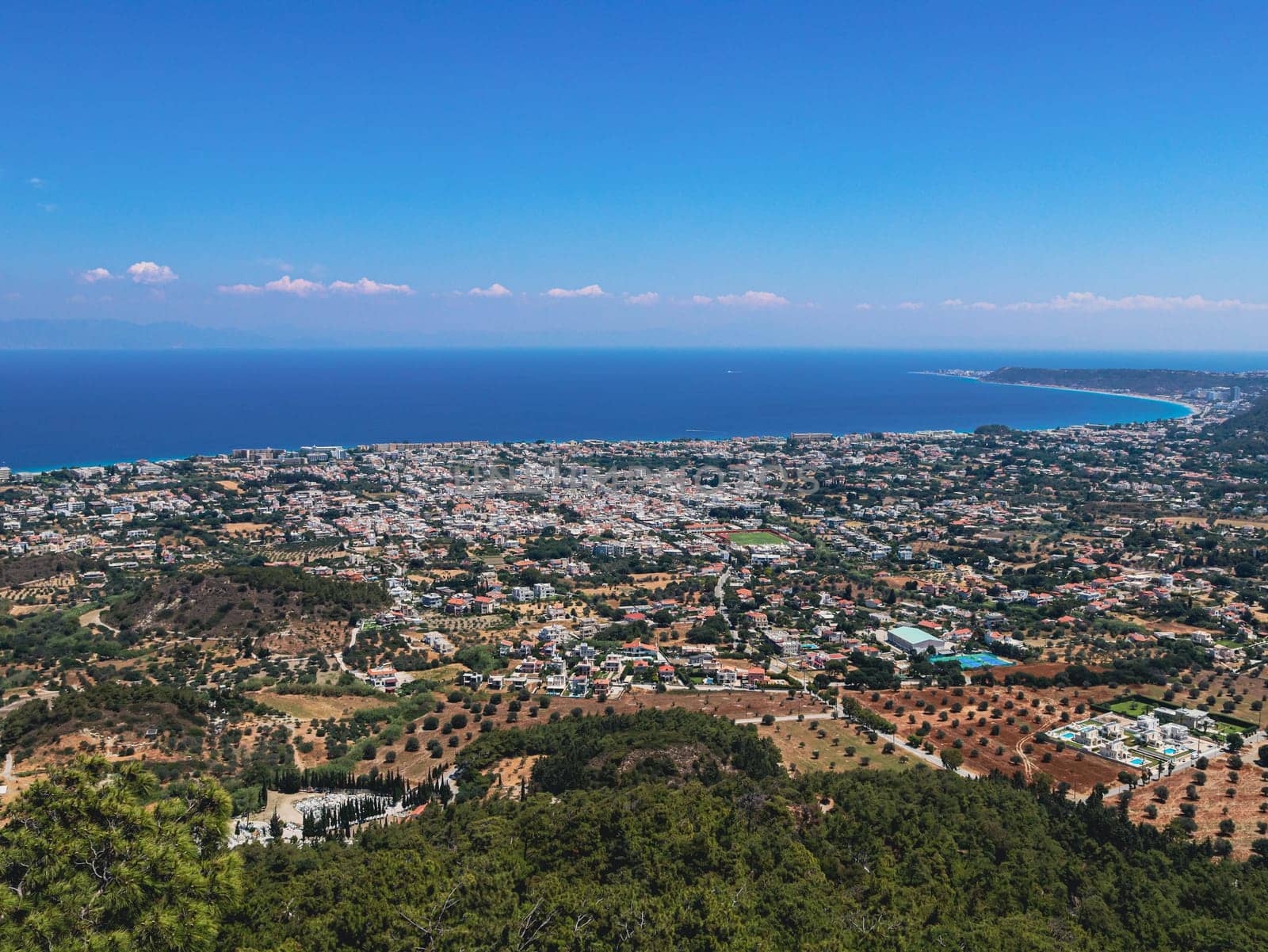 Beautiful panoramic view of the Aegean sea with the village and the blue sky from the Filerimos mountain in Greece on the island of Rhodes, close-up side view.