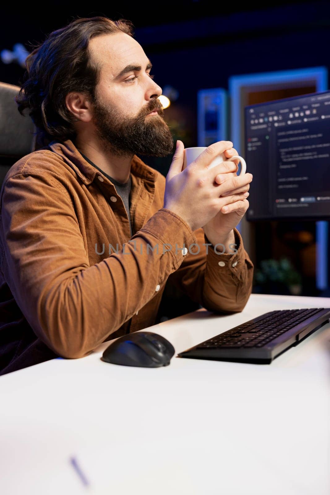 Programmer drinking coffee and writing lines of code filtering malicious traffic from cybercriminals attempting to steal company data. IT professional enjoying hot beverage, preventing malware