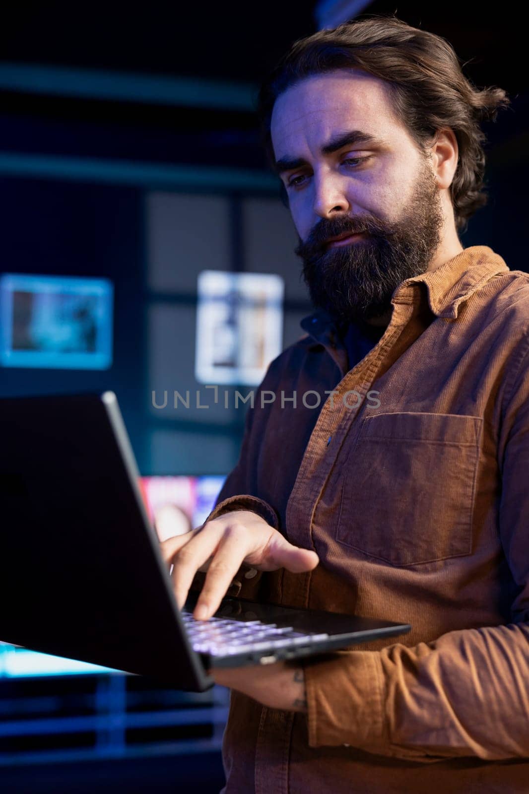 Programmer doing software quality assurance, reading source code on laptop by DCStudio