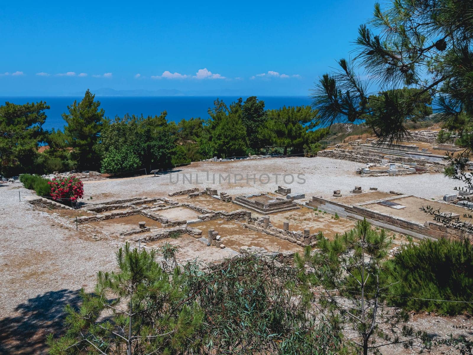 Beautiful panoramic view of the ruins of the historical medieval town of old Kamiros in a residential complex on top of a mountain overlooking the Aegean sea in Greece on the island of Rhodes on a summer sunny day, side view close-up.