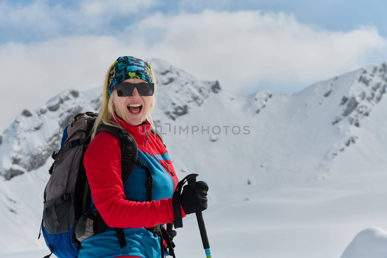 A Female Mountaineer Ascends the Alps with Backcountry Gear by dotshock