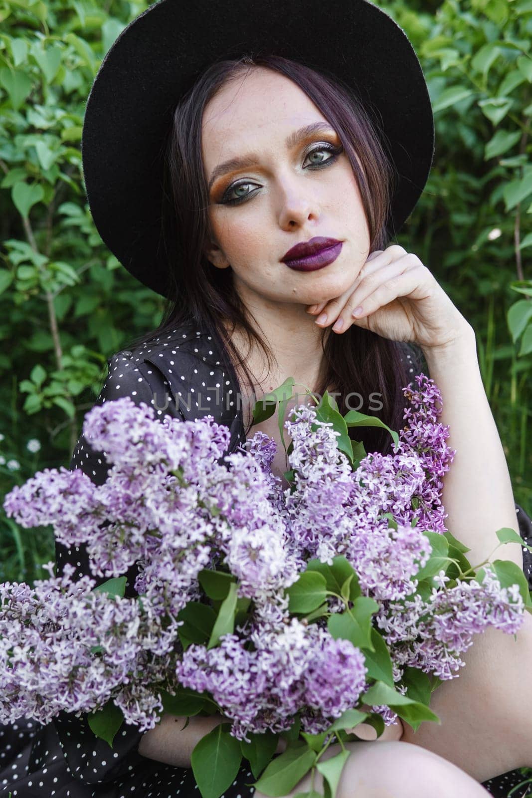 A fashionable girl with dark hair, a spring portrait in lilac tones in summer. Bright professional makeup. by Annu1tochka