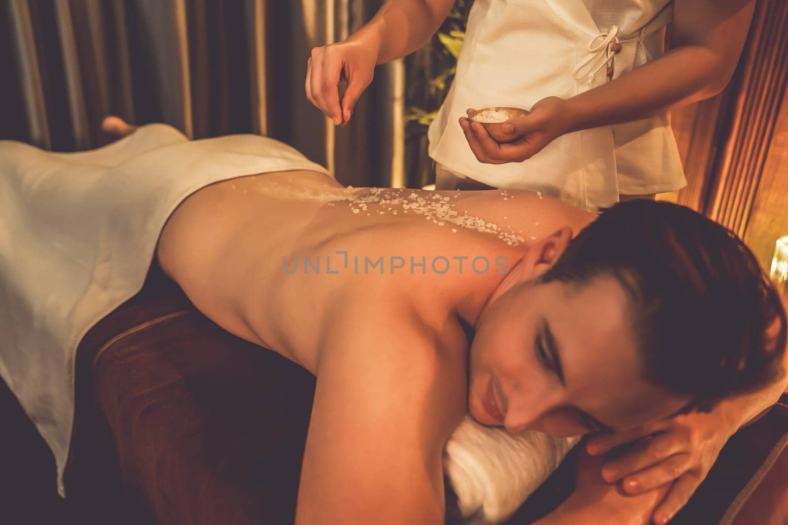 Man customer having exfoliation treatment in luxury spa. Quiescent by biancoblue