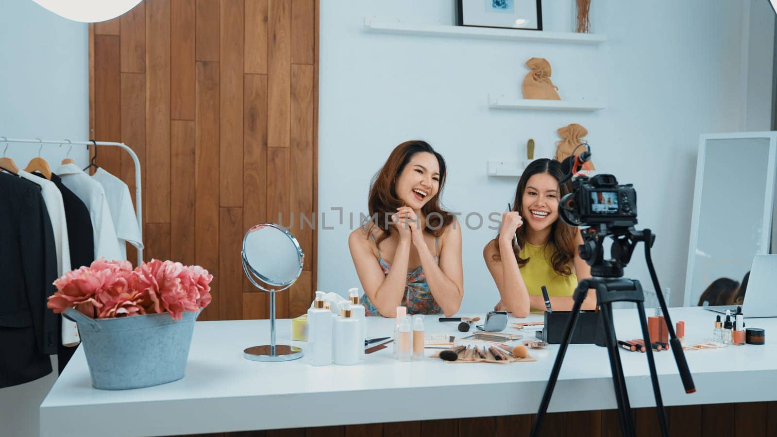 Two influencer partner shoot live streaming vlog video review makeup social media or blog. Happy young girl with vivancy cosmetics studio lighting for marketing recording session broadcasting online.