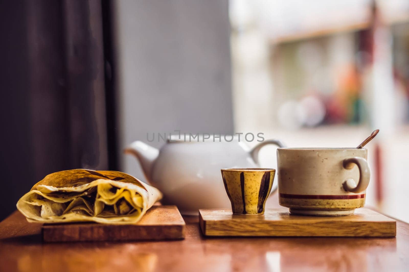 Mental warmth comfort calm silence. Breakfast cafe. Vintage matte photo. Ceramic kettle mug, large pancake on wooden board.