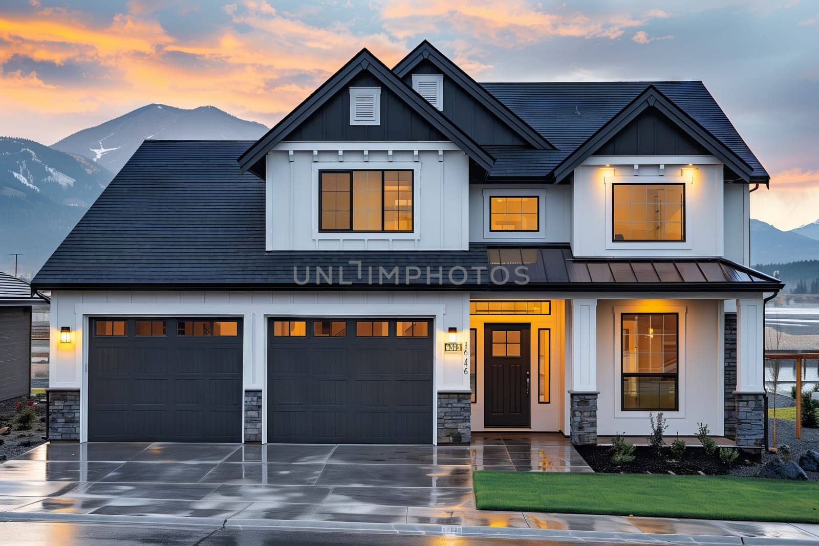 a large white and black house with a black garage door and mountains in the background . High quality