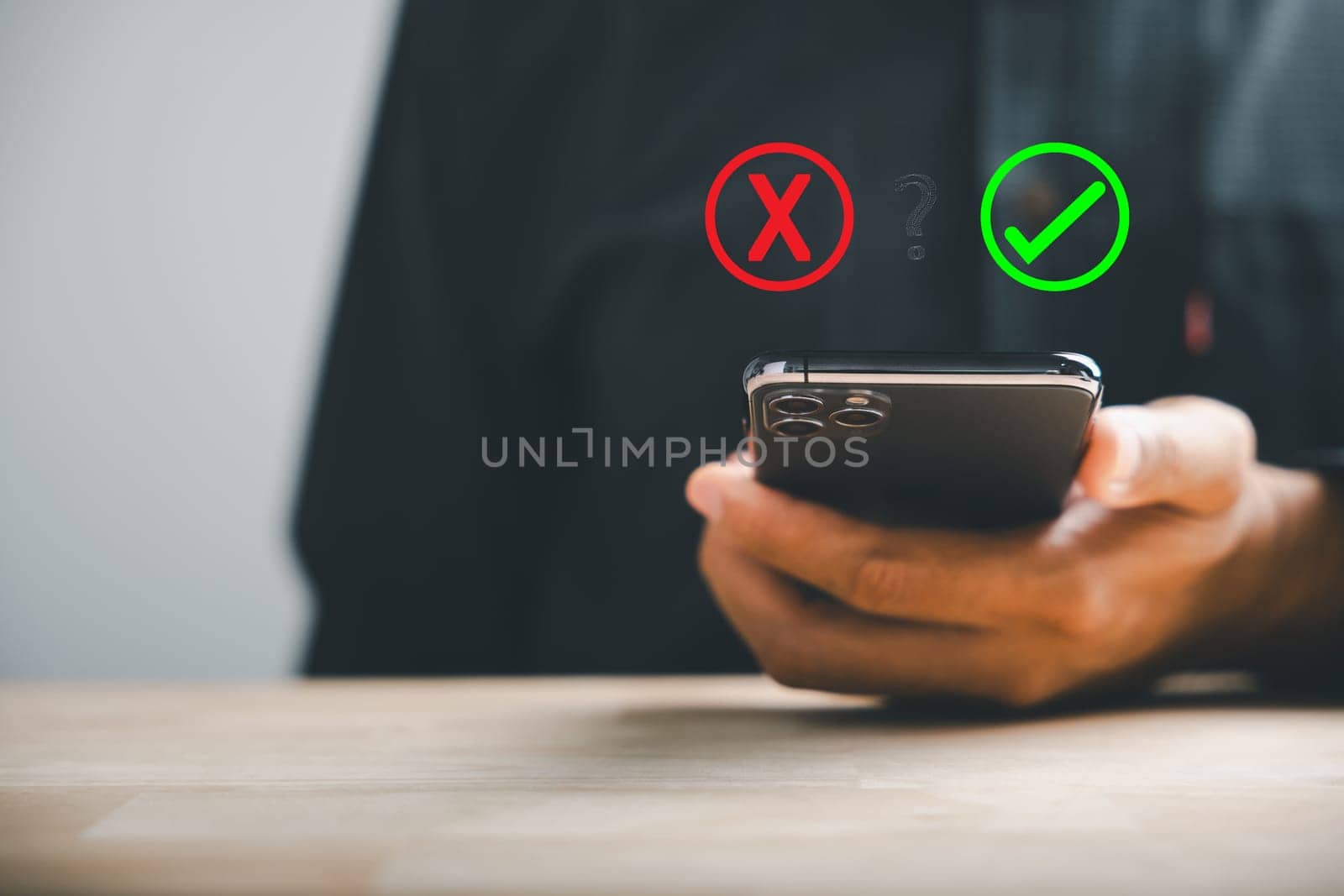 Using smartphones businessman reveals right and wrong icons for yes or no decision-making. Communication of choice and expertise. Think With Yes Or No Choice. by Sorapop