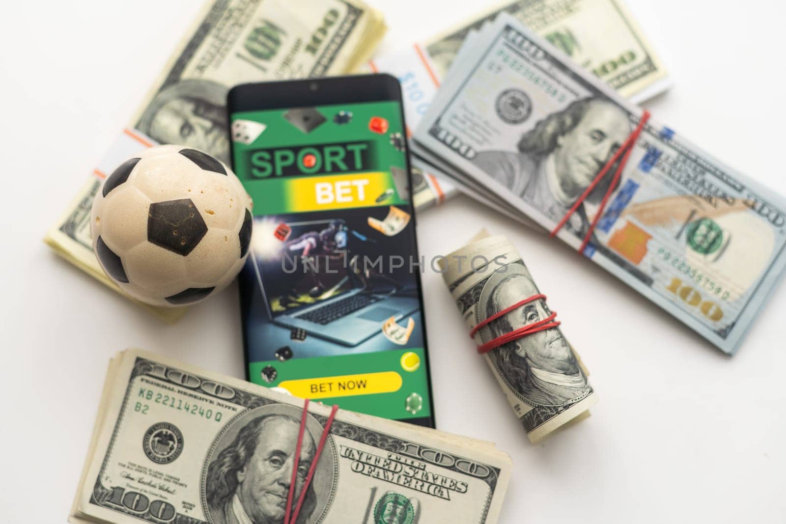 tablet pc with app for sport bets, on top of stacks of banknotes, white background, concept of online bets 3d render.