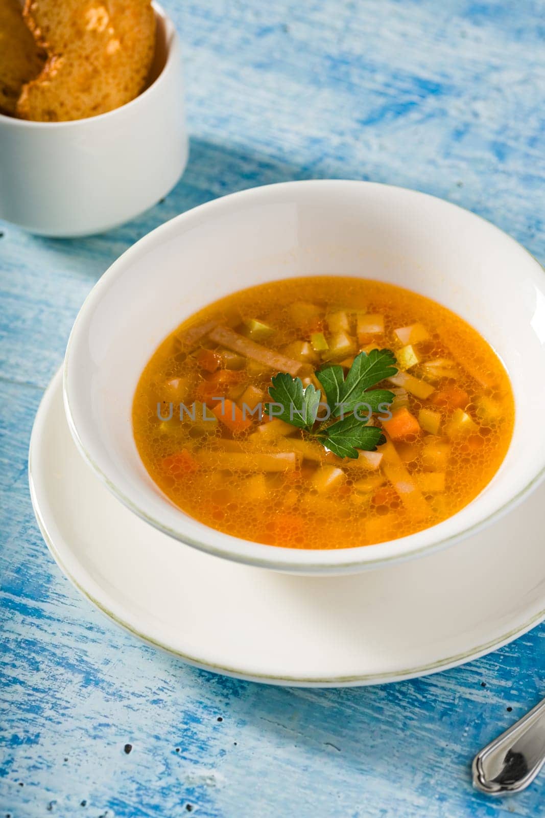 Top view of healthy vegetable soup on white porcelain plate by Sonat