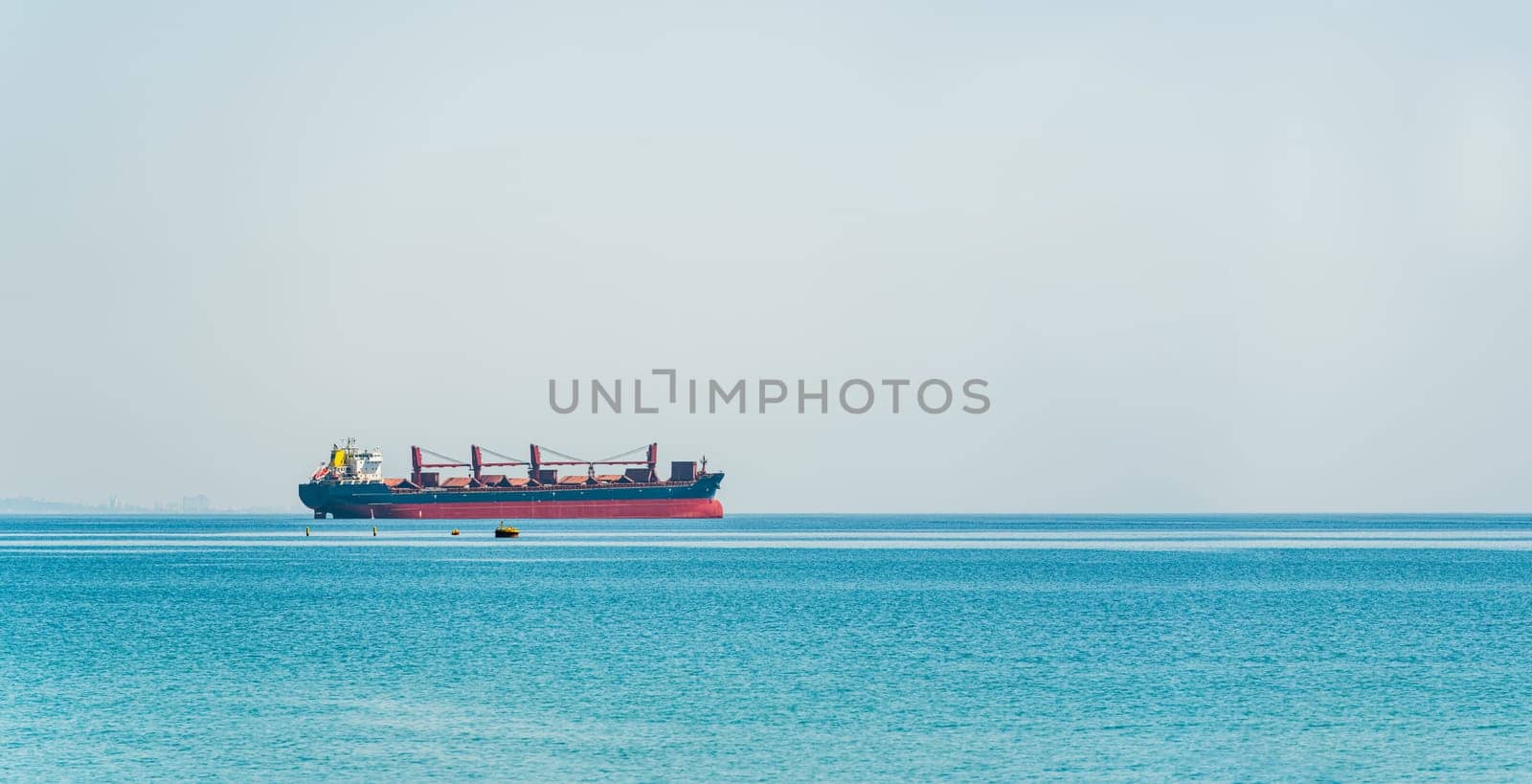 Bulk carrier ship waiting at the port entrance of the city