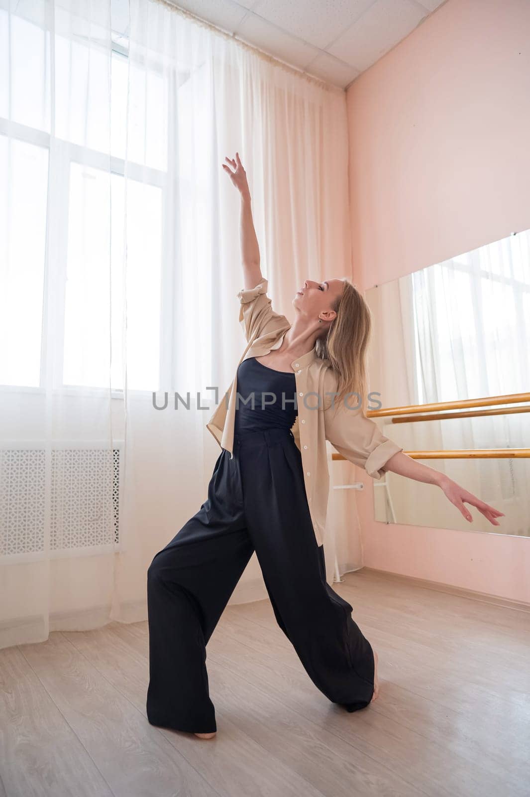 Caucasian woman dancing contemporary in ballet class. Rehearsal. Vertical photo. by mrwed54