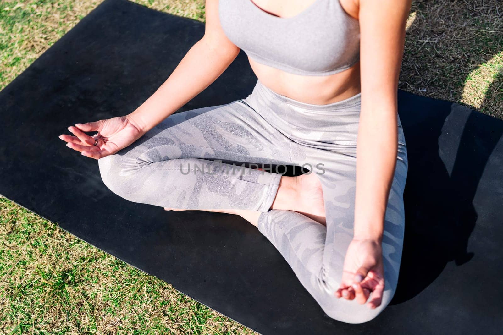 crossed legs of a woman doing yoga meditation by raulmelldo