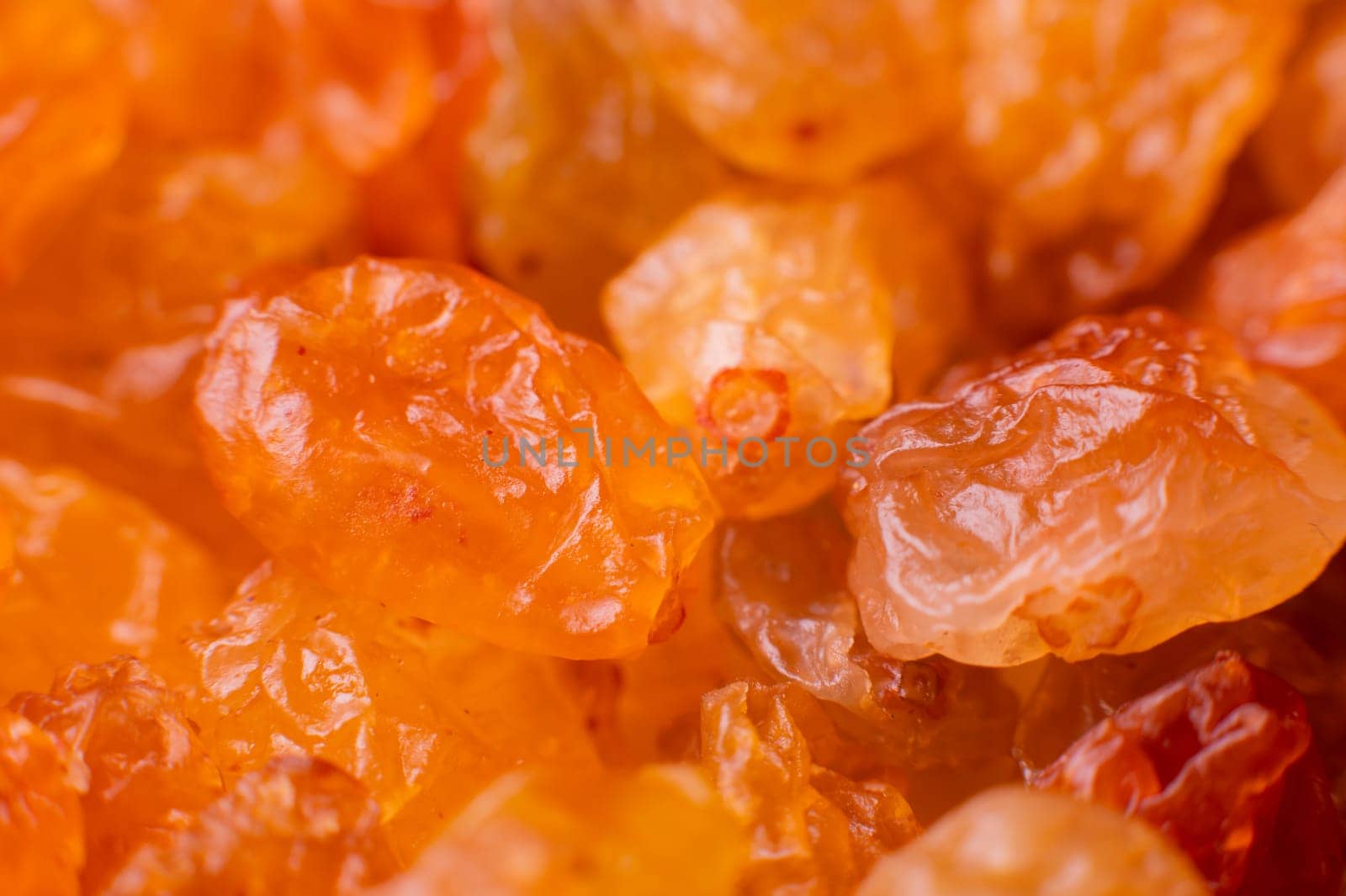 Background of a large number of dried yellow golden grapes. Raisin. Vegetarian diet by yanik88