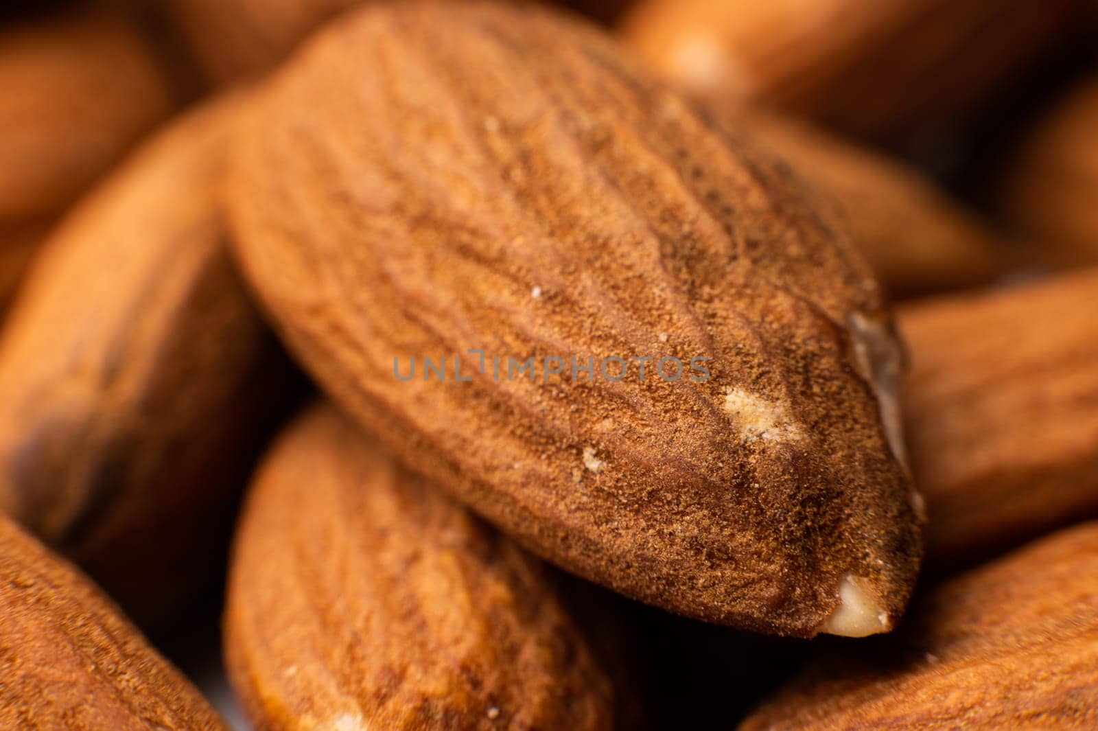 Background of big raw peeled almonds situated arbitrarily. by yanik88