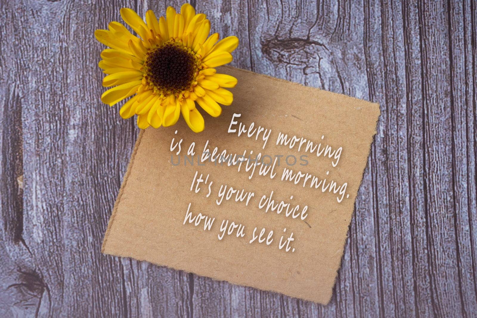 Motivational on brown note with gerbera yellow flower on wooden surface - Every morning is a beautiful morning, it is your choice how you see it.