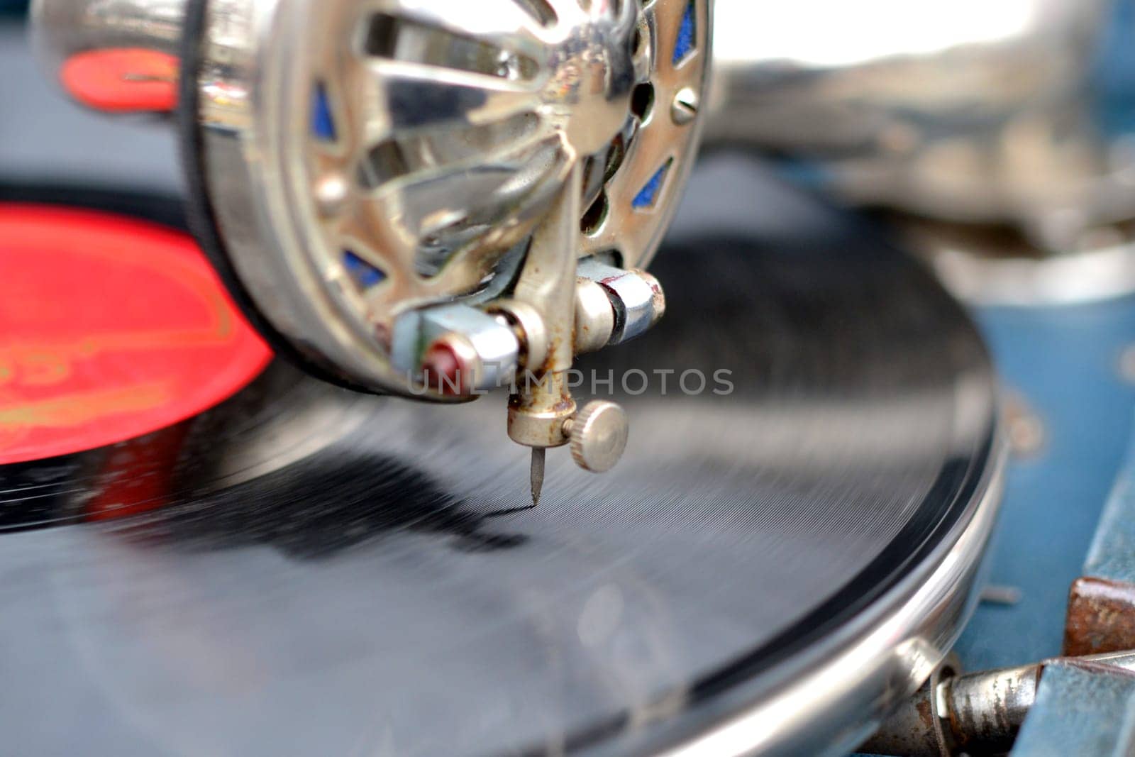 An old retro record playing on old vintage gramophone at flea market. by Mari1408