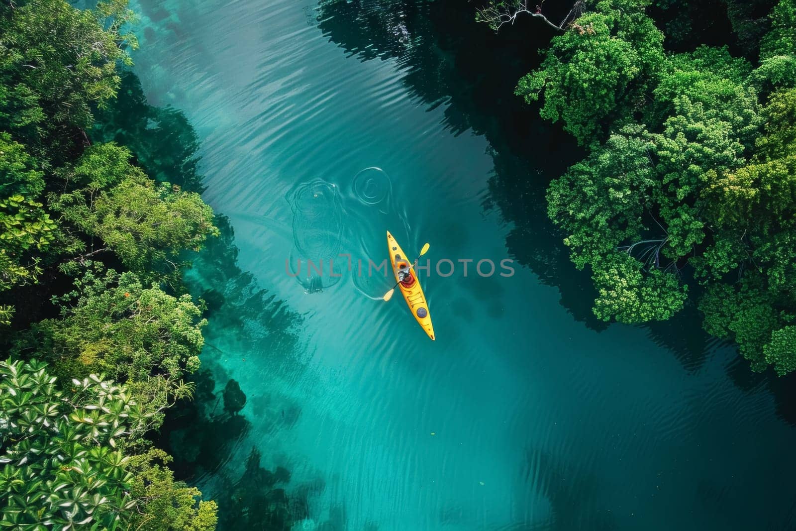 A vibrant kayak slices through the azure waters of a lagoon, surrounded by lush greenery and towering cliffs, an adventure in paradise.