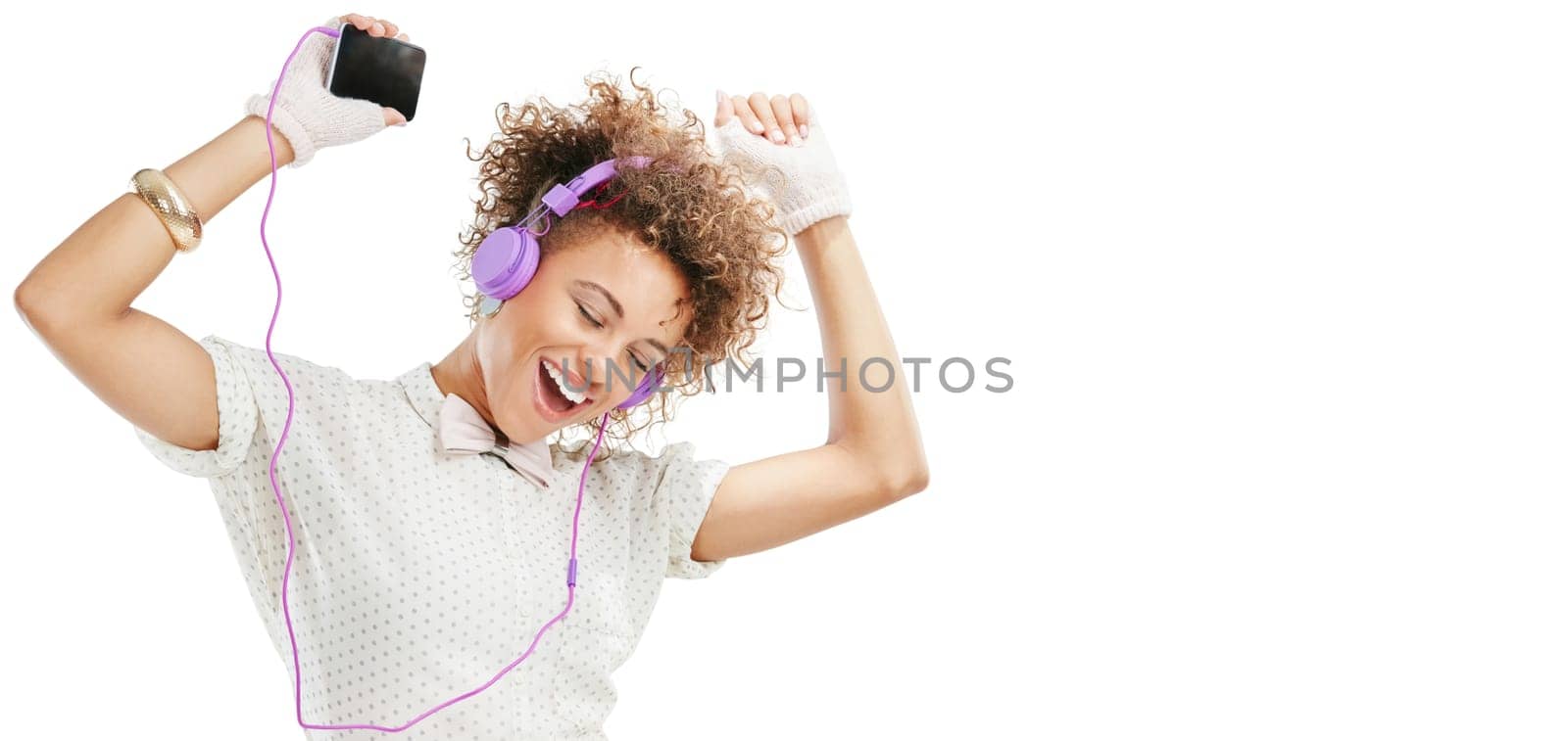 Woman, energy and dancing with smartphone, headphones for music and happiness isolated on white background. Excited, moving and listening to radio playlist for fun, mockup space or banner with joy.