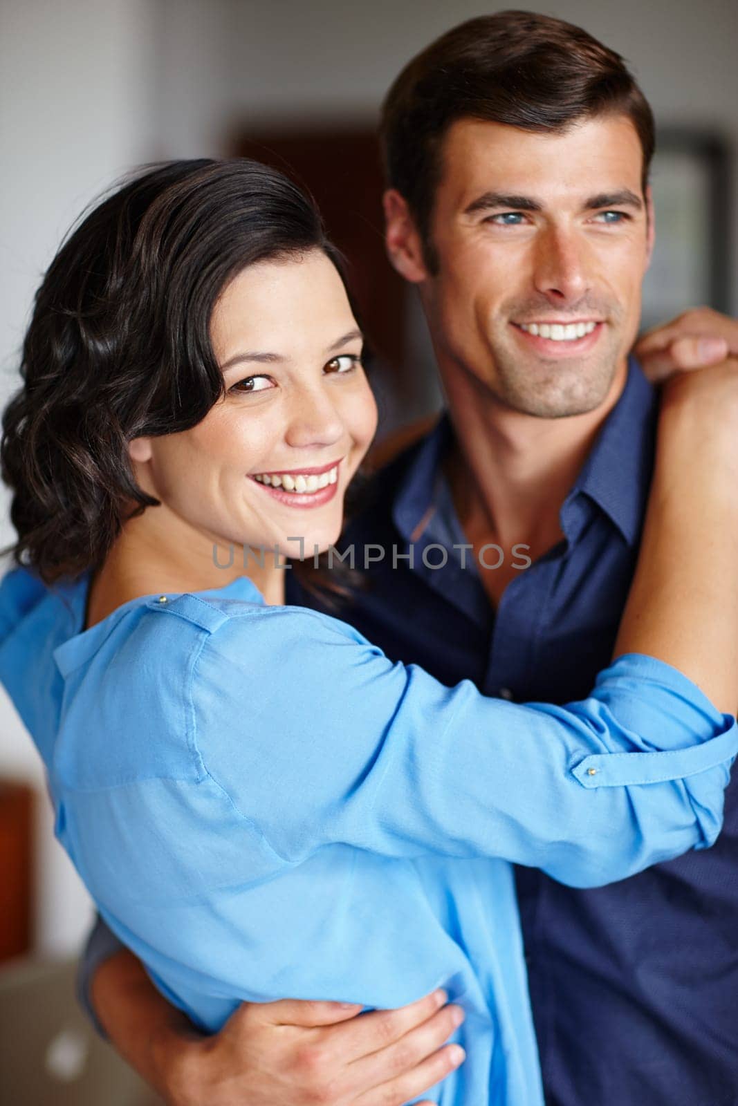 Couple, together and happy hug in portrait for love, romance and memories. Man, woman and intimate embrace for relationship smiling for passion, connection or bonding affectionate and caring.