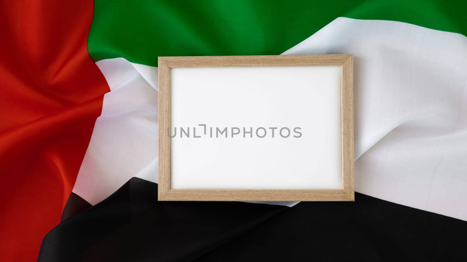 Empty white paper frame template National symbol of UAE. United Arab Emirates small flag with Peregrine falcon on neutral beige background. Copy space for your text. Concept of National day Independence