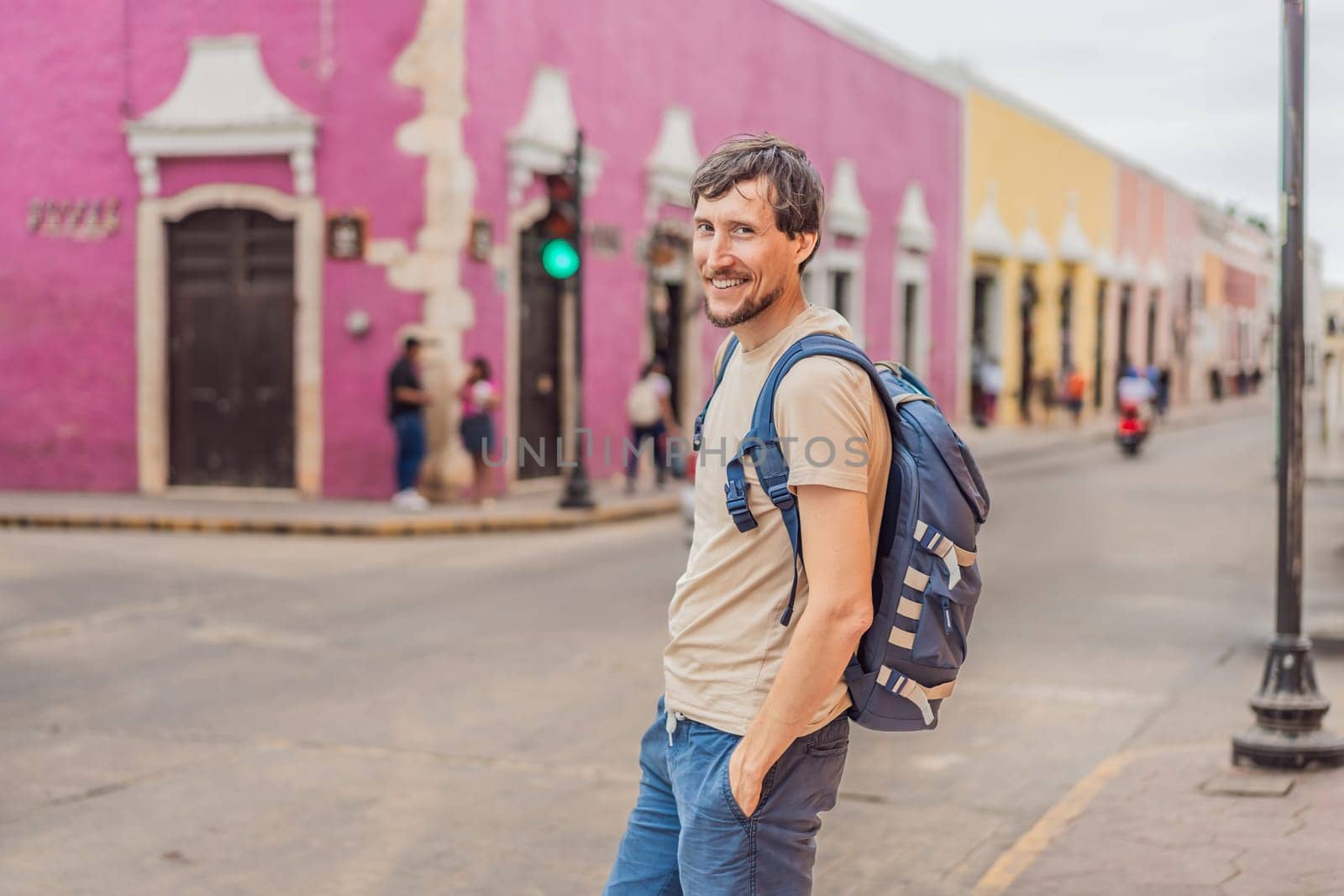 Man tourist explores the vibrant streets of Valladolid, Mexico, immersing herself in the rich culture and colorful architecture of this charming colonial town by galitskaya