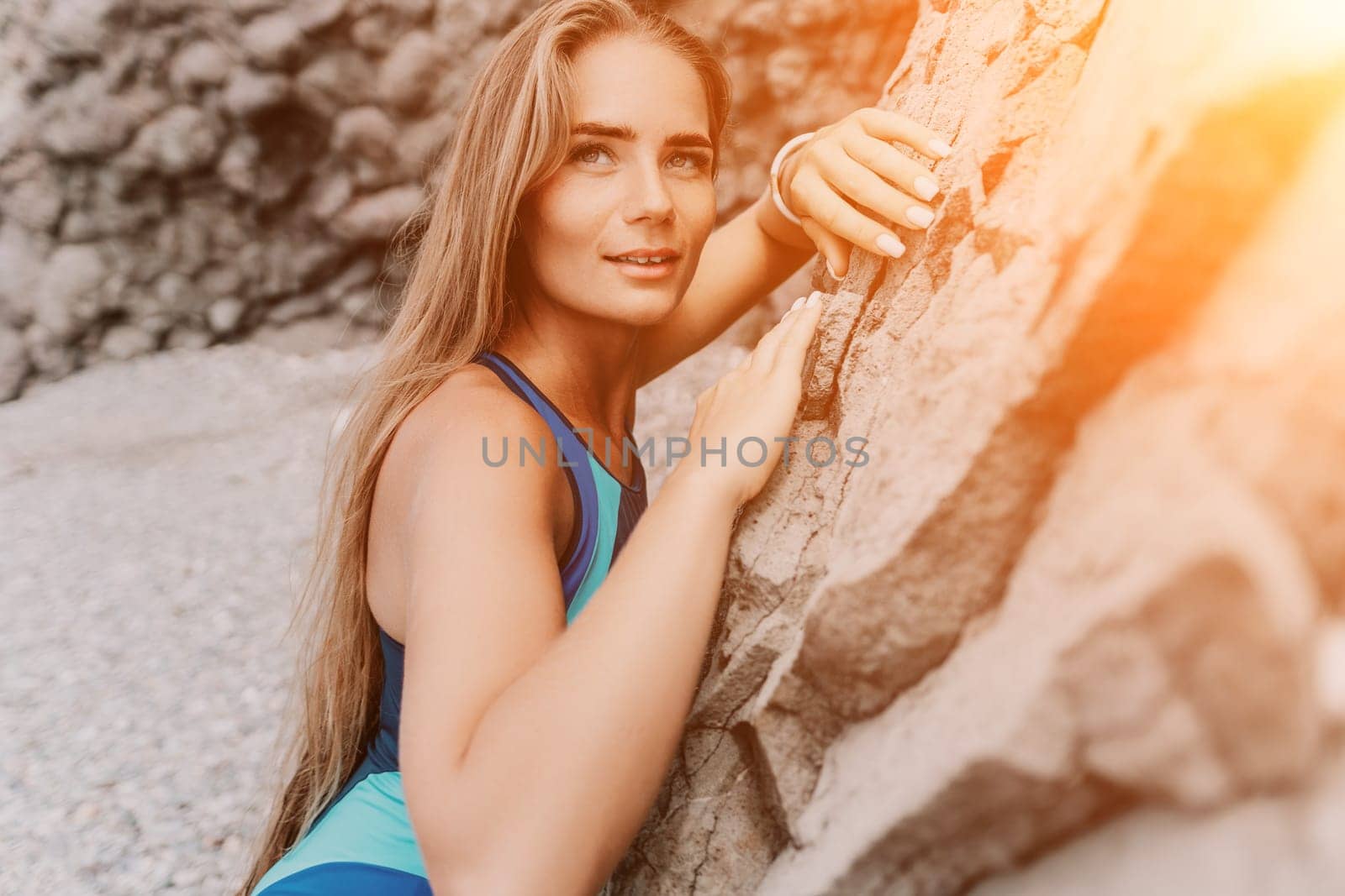 Woman summer travel sea. Happy tourist in blue bikini enjoy taking picture outdoors for memories. Woman traveler posing on the beach surrounded by volcanic mountains, sharing travel adventure journey by panophotograph