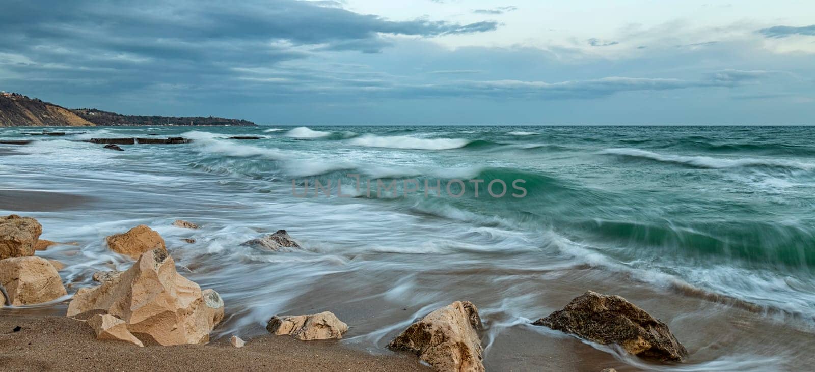 Stunning panoramic seascape with waves flowing between rocks. by EdVal