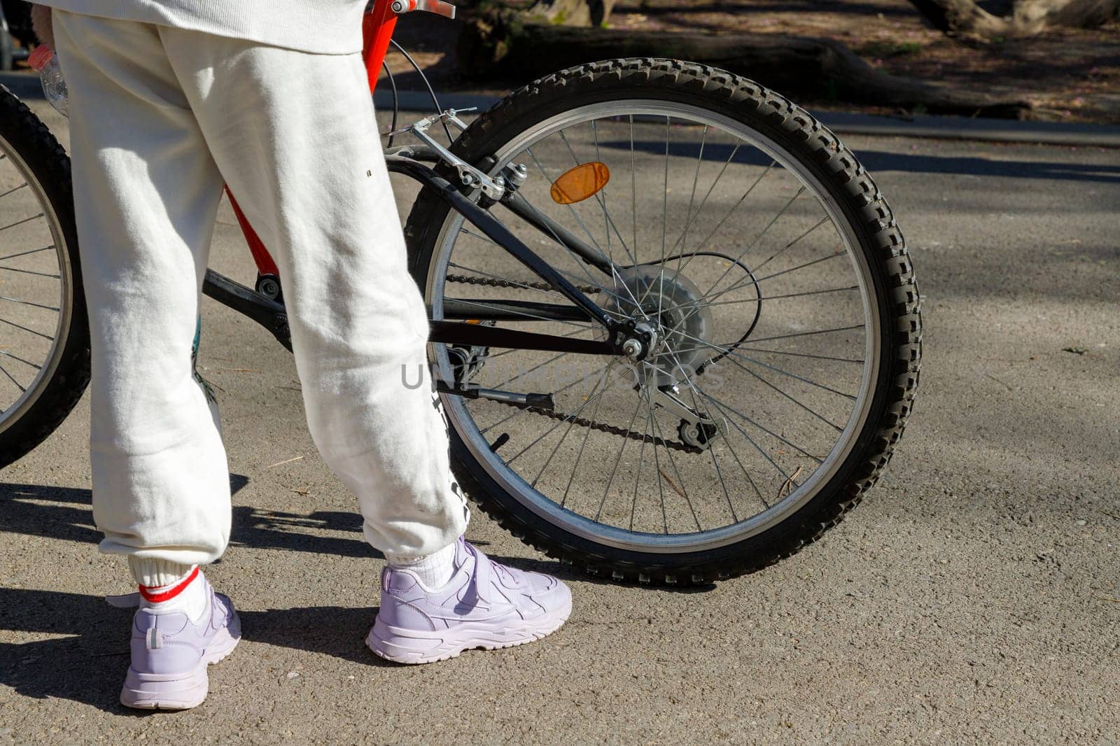 Cyclist waiting with bike in the garden, concept of freedom and sport in nature by EdVal