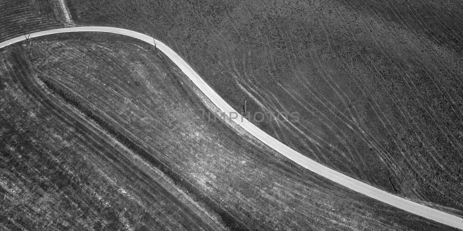 Abstract aerial view of road in the field. Black and white