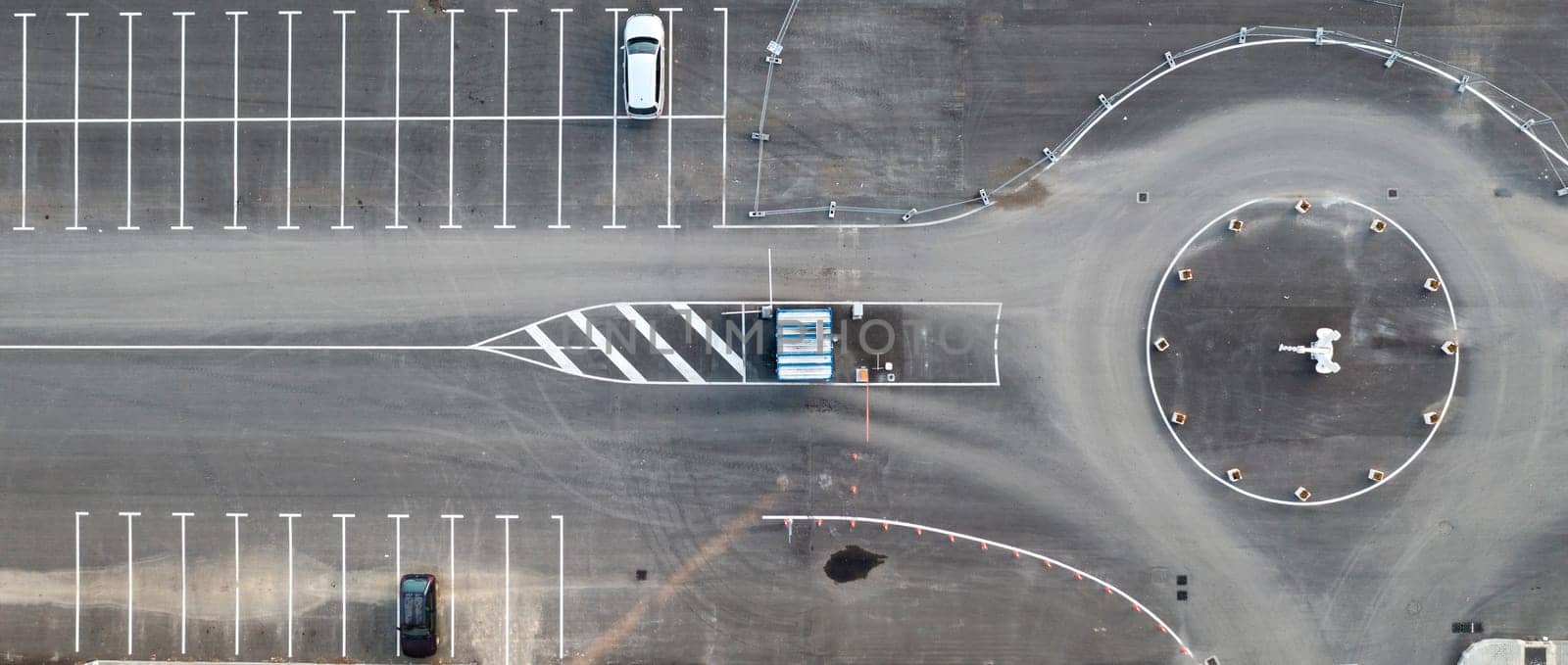 Abstract aerial view from a drone of circle junction road and car parking by EdVal