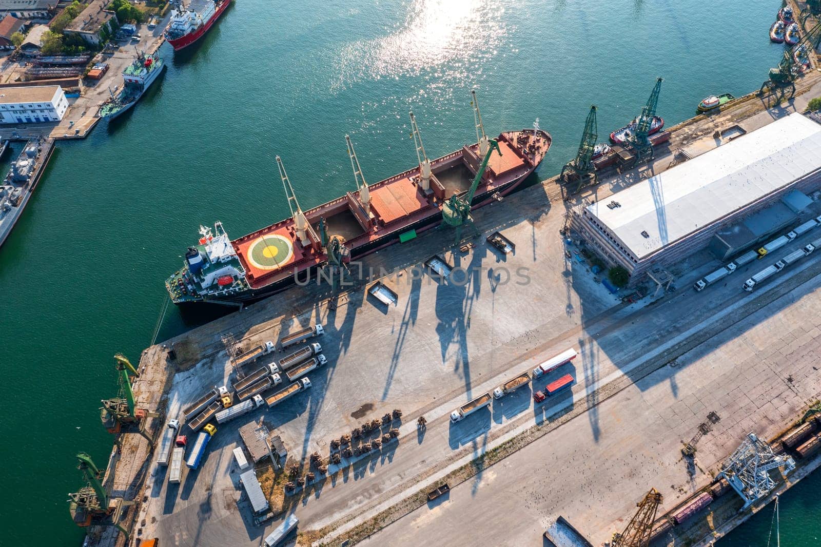 Aerial view of a large ship loading grain for export. Water transport 