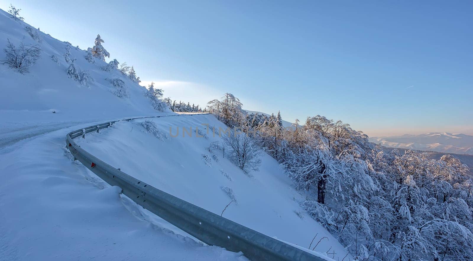 winter road on the mountain hill. The concept of winter travel by car.