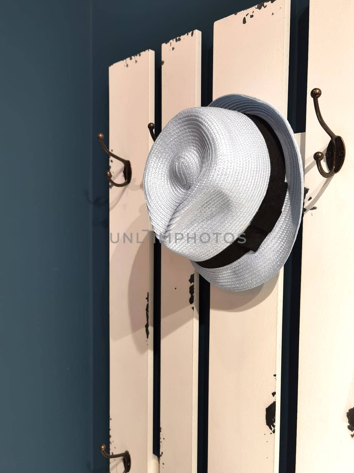 Old White hat on a hanger by EdVal