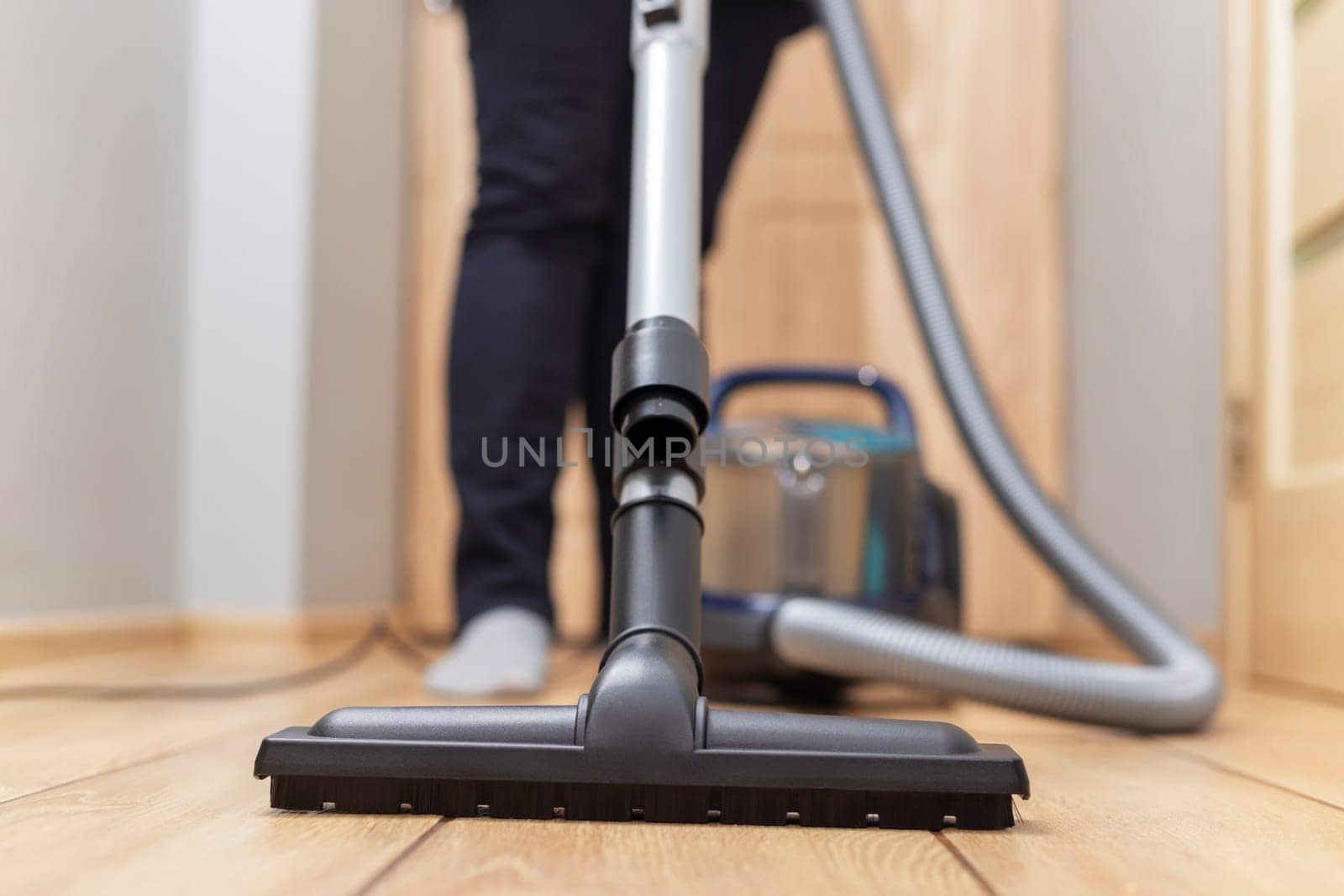 Person vacuuming floor. Household chore and cleaning concept. by andreyz